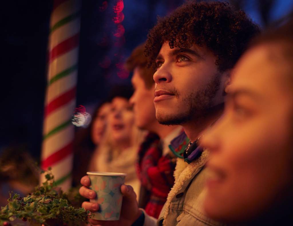 A group of friends outside at a Christmas holiday celebration.